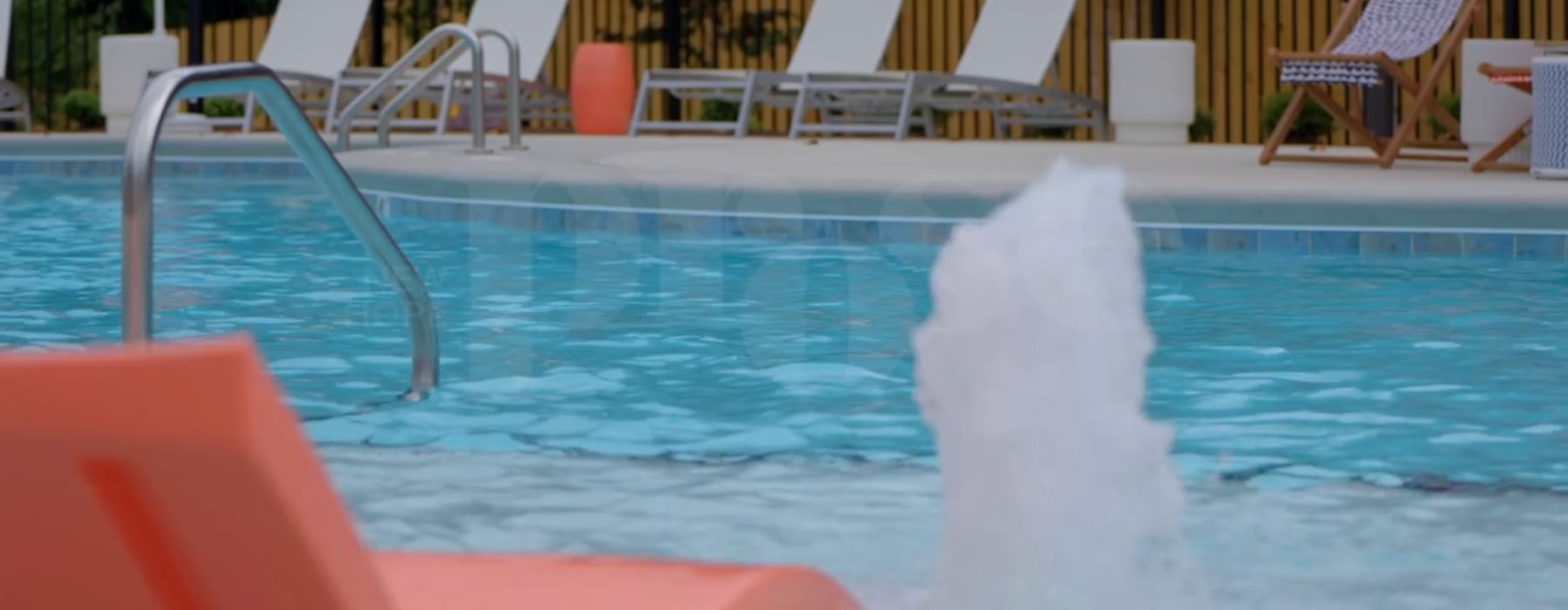 a swimming pool with lounge chairs